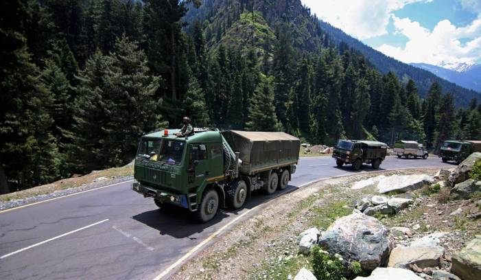 Army soldiers ride in a convoy along a highway leading towards Leh bordering China in Gagangir on Wednesday